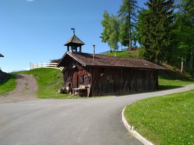 A wooden chapel transformed into a workshop, or a workshop with a bell